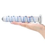 a fluted glass dildo in hand